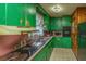 Galley kitchen with green cabinetry, a black refrigerator, and light fixtures at 1024 Locksley Dr, Charleston, SC 29407