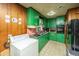 View of the kitchen featuring green cabinets, a black refrigerator, and laundry hookups at 1024 Locksley Dr, Charleston, SC 29407
