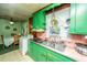 Eat-in kitchen with green cabinets, appliances, and laundry area in view at 1024 Locksley Dr, Charleston, SC 29407