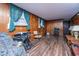 Inviting living room with wood paneling, hardwood floors, and large windows at 1024 Locksley Dr, Charleston, SC 29407