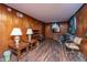 Comfortable living room with ample natural light, wood paneling, and hardwood floors at 1024 Locksley Dr, Charleston, SC 29407