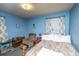 Blue main bedroom features a bed, recliner, and floral curtains at 1024 Locksley Dr, Charleston, SC 29407