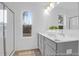 Bathroom featuring double vanity, large mirror, and a view to the outdoors at 1058 Marsh Harrier Dr # 15-7P, Ravenel, SC 29470
