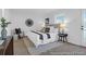 Bright bedroom featuring a large bed, stylish decorations, and a door to the outside at 1058 Marsh Harrier Dr # 15-7P, Ravenel, SC 29470