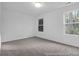Spacious, carpeted bedroom with two windows providing natural light, perfect blank canvas at 1058 Marsh Harrier Dr # 15-7P, Ravenel, SC 29470