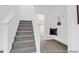 Welcoming entryway showcasing staircase, bench with hooks, and access to a half bathroom at 1058 Marsh Harrier Dr # 15-7P, Ravenel, SC 29470