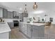 Modern kitchen with gray cabinets, stainless steel appliances, and a central island perfect for entertaining and cooking at 1058 Marsh Harrier Dr # 15-7P, Ravenel, SC 29470