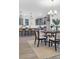 Bright kitchen features gray cabinets, island with seating, and a dining area with modern chandelier at 1058 Marsh Harrier Dr # 15-7P, Ravenel, SC 29470