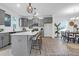 Open-concept kitchen boasts gray cabinets, stainless steel appliances, a large island with seating, and modern pendant lights at 1058 Marsh Harrier Dr # 15-7P, Ravenel, SC 29470