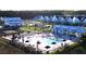 Aerial view of a sparkling community pool surrounded by lounge chairs and umbrellas at 1038 Marsh Harrier Dr # 15-7P, Ravenel, SC 29470