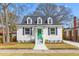 Charming two-story home with a bright green door, dormer windows, and well-maintained lawn at 104 Darlington Ave, Charleston, SC 29403