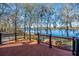 Spacious back deck with railings offering scenic views of the tranquil lake at 105 Goose Creek Dr, Goose Creek, SC 29445