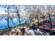 Lakeside backyard with mature trees, patio, and a beautiful view from the deck at 105 Goose Creek Dr, Goose Creek, SC 29445