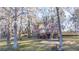 Home's backyard offers a deck, patio, and views of a serene lake surrounded by trees at 105 Goose Creek Dr, Goose Creek, SC 29445