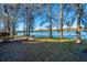 Expansive backyard overlooking a serene lake, framed by trees draped with Spanish moss at 105 Goose Creek Dr, Goose Creek, SC 29445