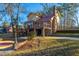 Rear view of home with a brick and siding exterior, featuring a deck and a well-kept backyard at 105 Goose Creek Dr, Goose Creek, SC 29445