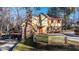 Exterior view of a well-kept home that features a brick chimney, red roof and lake views at 105 Goose Creek Dr, Goose Creek, SC 29445