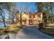 Charming two-story home featuring brick and siding, a red roof, and a curved driveway leading to the entrance at 105 Goose Creek Dr, Goose Creek, SC 29445