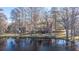 Scenic lakefront home surrounded by trees draped with Spanish moss at 105 Goose Creek Dr, Goose Creek, SC 29445