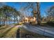 Picturesque yellow waterfront home with a red roof and a long driveway leading to tranquility and beauty at 105 Goose Creek Dr, Goose Creek, SC 29445