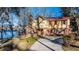 Exterior of home with a red roof overlooking the tranquil lake, with mature trees at 105 Goose Creek Dr, Goose Creek, SC 29445