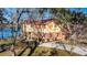 Charming two-story home with red roof and shutters, nestled beside a picturesque lake at 105 Goose Creek Dr, Goose Creek, SC 29445