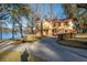 Lovely yellow two-story home with red accents, waterfront access, and a spacious driveway for easy parking at 105 Goose Creek Dr, Goose Creek, SC 29445