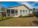 A charming home featuring a cozy screened-in porch, set in a well-maintained backyard at 106 Willet Dr, Summerville, SC 29485