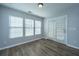 Corner bedroom with wood-look floors, natural light, and access to the backyard through glass doors at 106 Willet Dr, Summerville, SC 29485