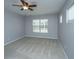 A cozy bedroom with a ceiling fan and large window providing natural light and ventilation at 106 Willet Dr, Summerville, SC 29485