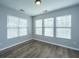 Bright bedroom features wood-look floors, light gray walls, and ample natural light from three windows at 106 Willet Dr, Summerville, SC 29485
