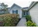 Welcoming front entrance with tidy landscaping leading to a glass-paneled front door and sidelight at 106 Willet Dr, Summerville, SC 29485