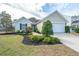 Charming single-story home with manicured lawn, mature landscaping, and a two-car attached garage at 106 Willet Dr, Summerville, SC 29485