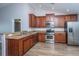 Modern kitchen with stainless steel appliances, wood cabinets, and vaulted ceiling at 106 Willet Dr, Summerville, SC 29485