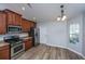 Eat-in kitchen featuring wood cabinets, stainless steel appliances, and a large window at 106 Willet Dr, Summerville, SC 29485