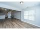 Open-concept living area with wood floors, view of the kitchen, and great natural light through large windows at 106 Willet Dr, Summerville, SC 29485