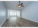 Bright, open living room with durable wood flooring, fan, ample natural light, and neutral paint scheme at 106 Willet Dr, Summerville, SC 29485