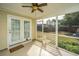Screened porch with tiled flooring that steps out to the home's backyard and landscaping at 106 Willet Dr, Summerville, SC 29485