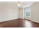 Bright bedroom with vaulted ceiling, ceiling fan, wood floors and large window at 1122 St Pauls Parrish Ln, Johns Island, SC 29455