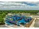 Aerial shot showcases a playground with shade sails, a parking lot, and a baseball field in a beautiful setting at 1195 Marquis Rd, North Charleston, SC 29405