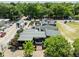 Commercial building with covered outdoor seating, umbrellas, and ample parking, surrounded by lush trees at 1195 Marquis Rd, North Charleston, SC 29405