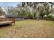 Spacious backyard with a shed, wooden deck, and leafy trees at 1195 Marquis Rd, North Charleston, SC 29405