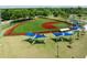 Aerial view of a well-maintained baseball field featuring covered picnic tables, lush green outfield, and protective fencing at 1195 Marquis Rd, North Charleston, SC 29405
