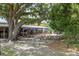 Outdoor patio area with umbrellas and picnic tables, under a large tree at 1195 Marquis Rd, North Charleston, SC 29405