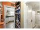 Hallway with built-in bookshelf leading to kitchen and bathroom with white wainscoting and shower at 1195 Marquis Rd, North Charleston, SC 29405