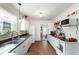 Functional kitchen featuring white cabinets, a tile backsplash, and an open view to the living area at 1195 Marquis Rd, North Charleston, SC 29405