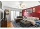 Inviting living room featuring a red accent wall, plush seating, and natural light through sliding doors at 1195 Marquis Rd, North Charleston, SC 29405
