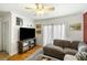 Bright living room with hardwood floors, a comfortable gray sofa, and sliding glass doors for natural light at 1195 Marquis Rd, North Charleston, SC 29405