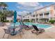 Inviting community pool surrounded by lounge chairs and lush landscaping at 130 River Landing Dr # 7309, Charleston, SC 29492