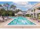 Relaxing community pool with clear blue water, numerous lounge chairs, and nearby buildings at 130 River Landing Dr # 7309, Charleston, SC 29492